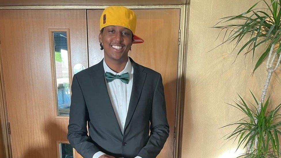 Eddie Kinuthia smiling in a bowtie and yellow cap