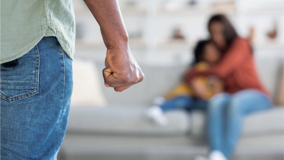 Unrecognizable Man Threatening Wife And Daughter With His Fist