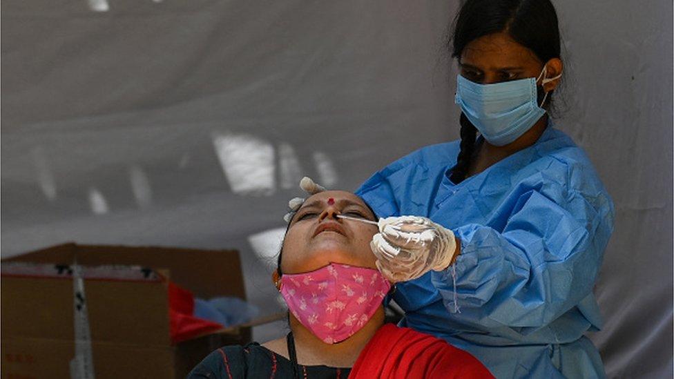 A woman gets tested in a Mumbai hospital for Covid-19