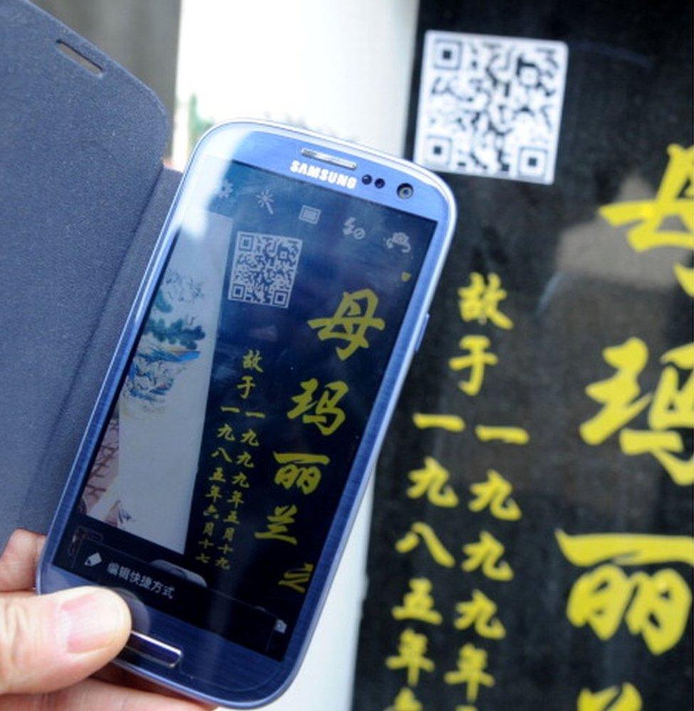 A two-dimensional quick response barcode (QR code) is affixed to a tombstone to offer smartphone users extended information about the person buried beneath on 4 April 2013 in Shenyang, Liaoning Province of China.