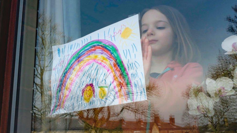 girl-with-rainbow-picture-in-window.