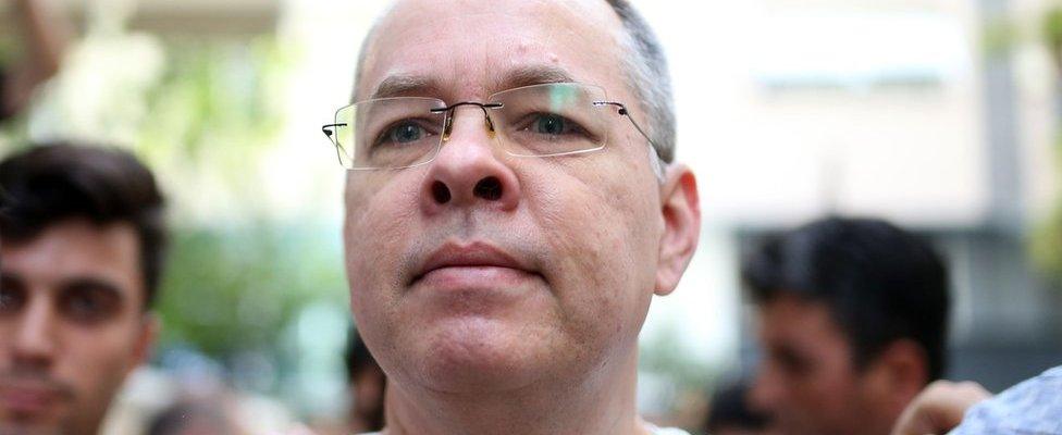 Pastor Andrew Craig Brunson is escorted by Turkish plainclothes police officers as he arrives at his house in Izmir, Turkey, 25 July 2018