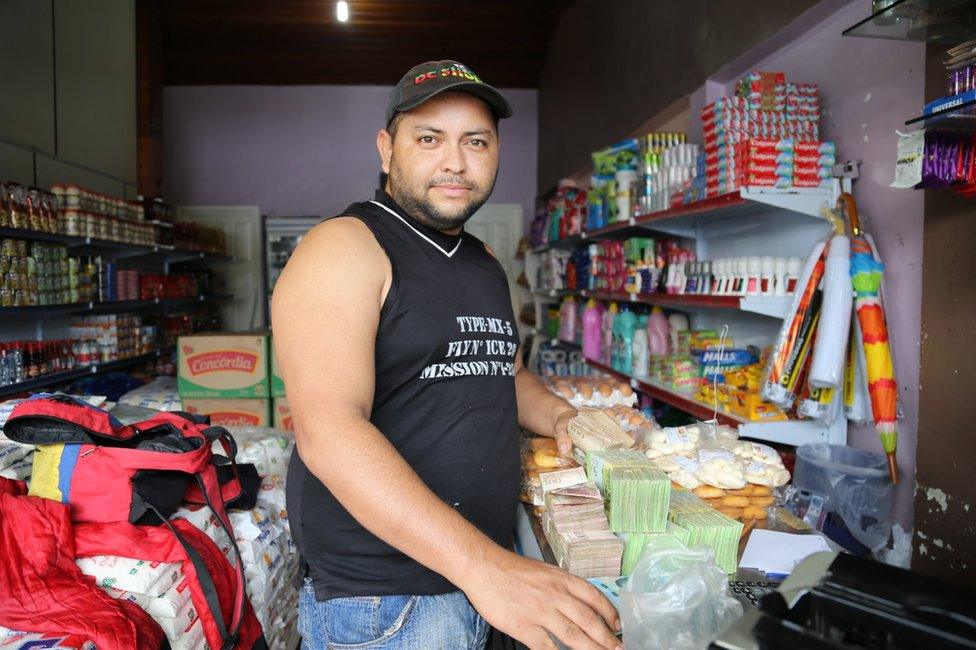 William Camero buys sugar in a shop in Pacaraima