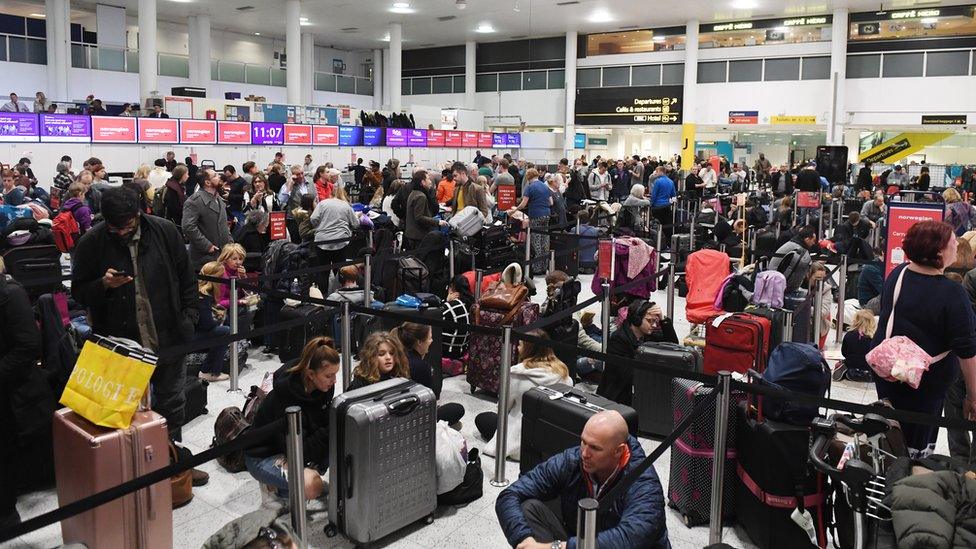 Crowds of people waiting at Gatwick Airport