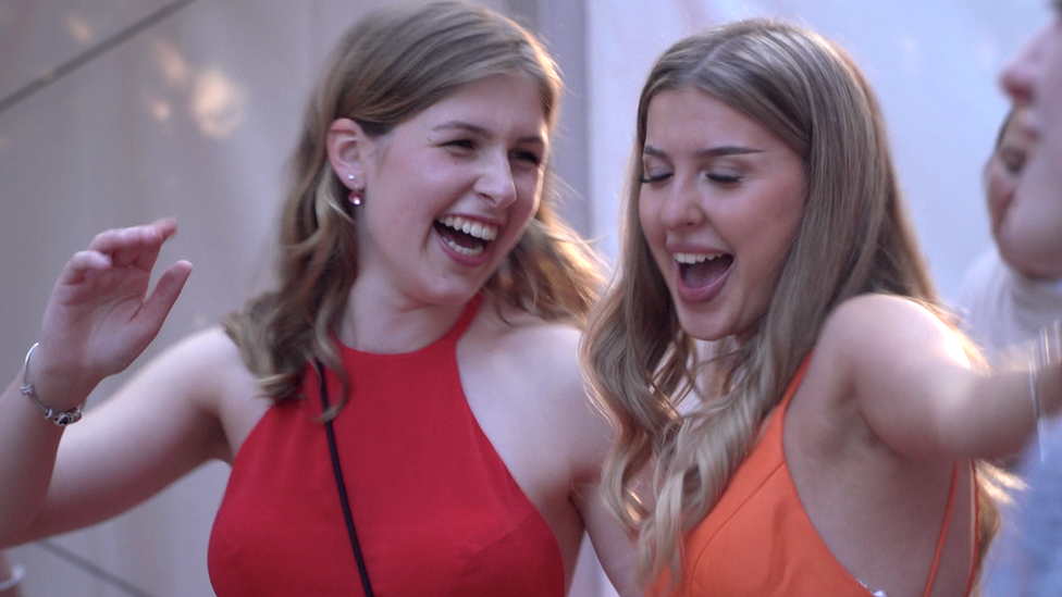 Alisa Gukasov (R) and classmate celebrate the end of school