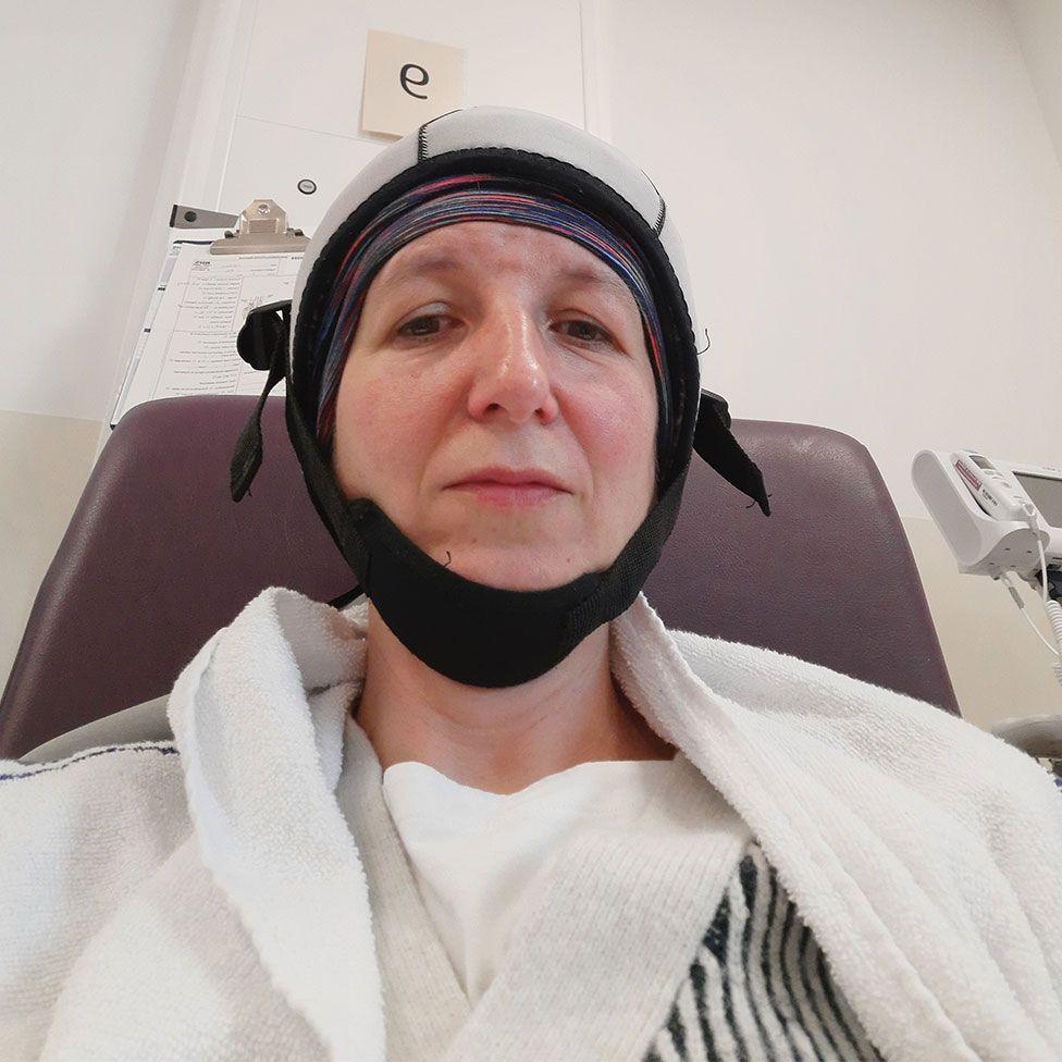 Nichola wearing cold cap in chemo ward