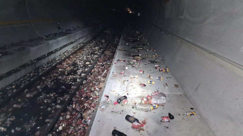 Thousands of products including wine, lemonade and tinned chopped tomatoes have been strewn across the tracks