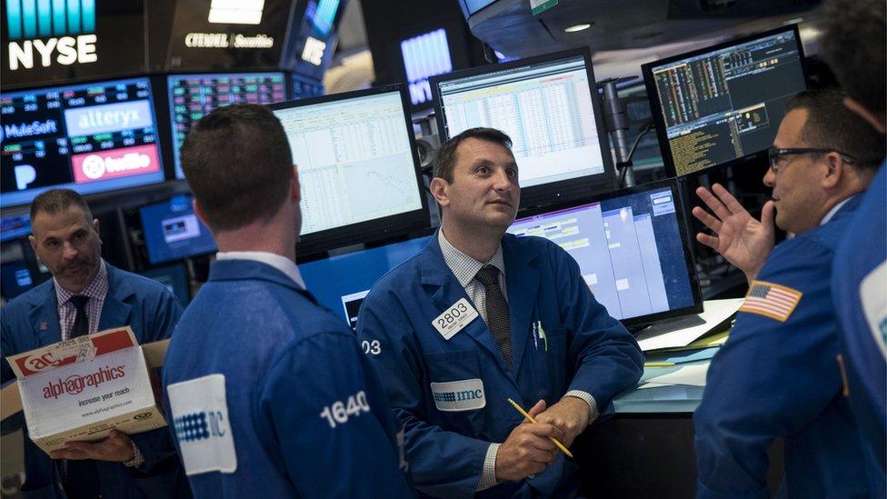 Traders work after news reports emerged about the Federal Reserve's decision to raise interest rates on the floor of the New York Stock Exchange (NYSE) June 14, 2017 in New York