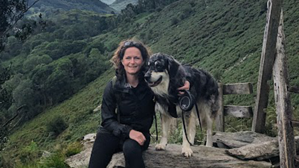 Hilary and Ziggy posing together on a mountain path