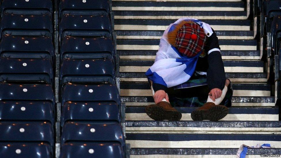 A Scotland fan looking dejected in the stands