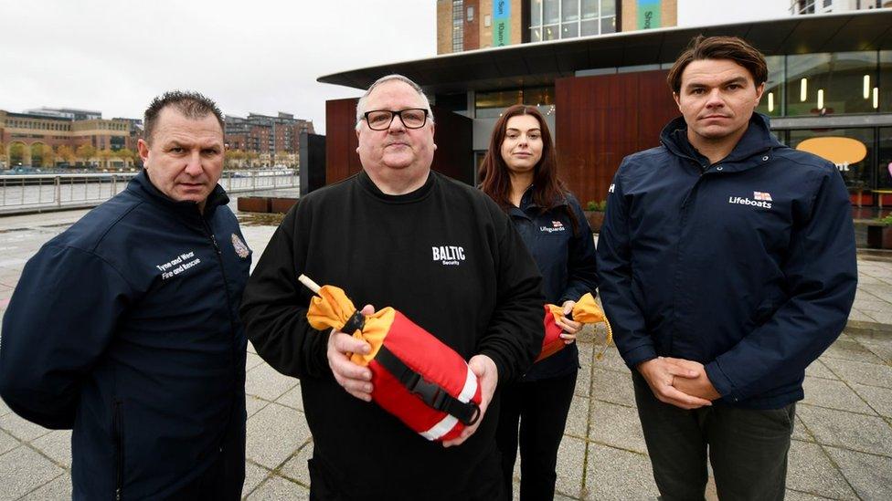 Mr Dickinson with a man and woman from the RNLI and man from TWFRS