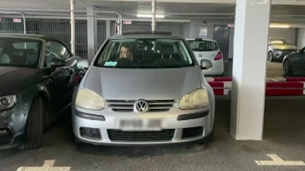 Cerys Gemma in her car in the parking space she has been allocated