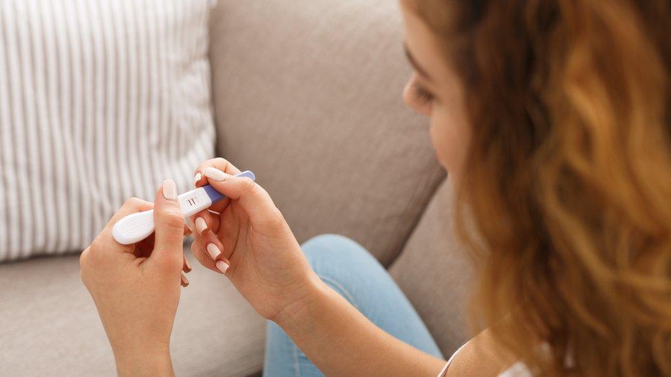 Woman looking at pregnancy test