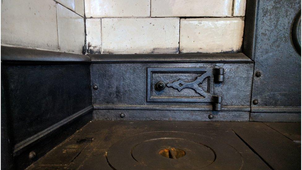 The tiles around the stove were imported from Kilmarnock