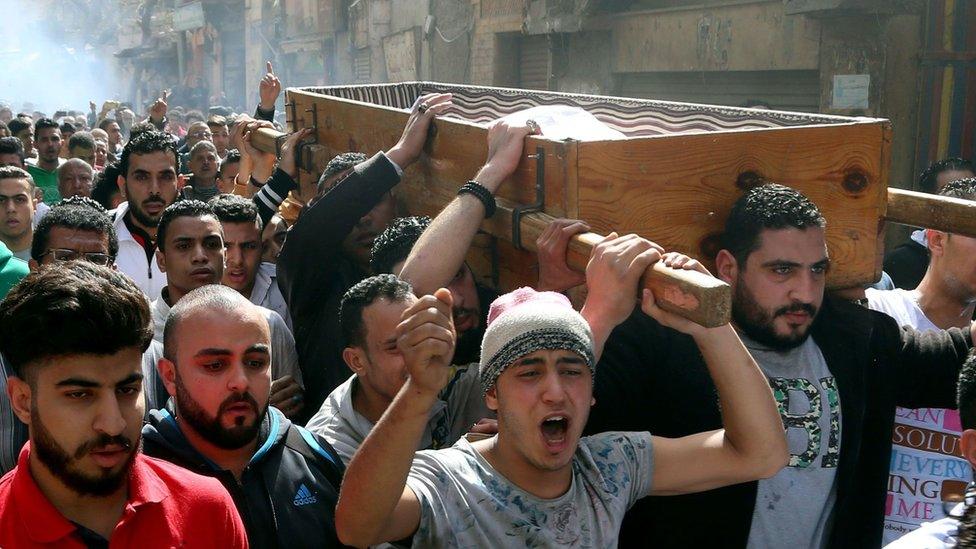 Egyptian mourners carry the coffin of Mohamed Ali Sayed Ismail, who was allegedly shot dead by a policeman over a fare dispute the day before, during his funeral on February 19, 2016