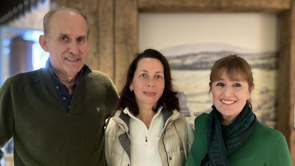 A group of three people looking at the camera with Alevtina Piklarska in the centre