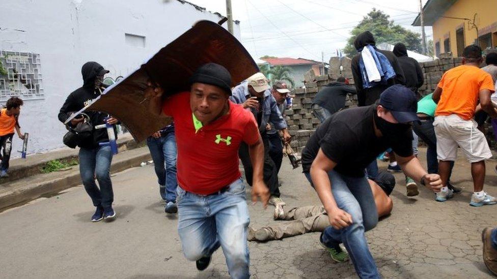 Demonstrators take cover as police fire at them during a protest against the government of Nicaraguan President Daniel Ortega in Masaya, Nicaragua June 19, 2018.