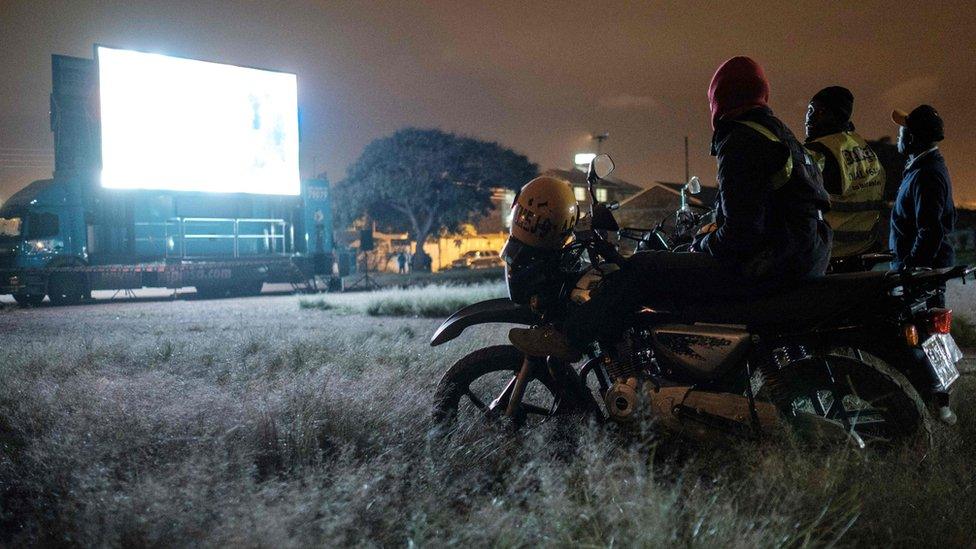 Kenyans on bikes watch a football match on a giant screen in Nairobi - Tuesday 26 June 2018