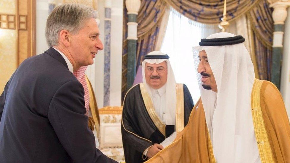 Saudi King Salman bin Abdulaziz shakes hands with Britain's Foreign Secretary Philip Hammond