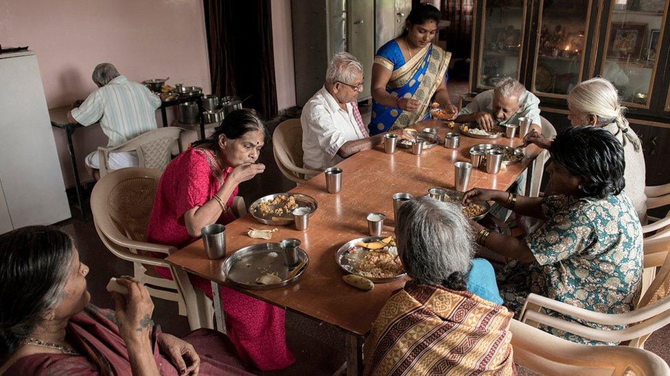 Several of home's residents eating a meal at the care home