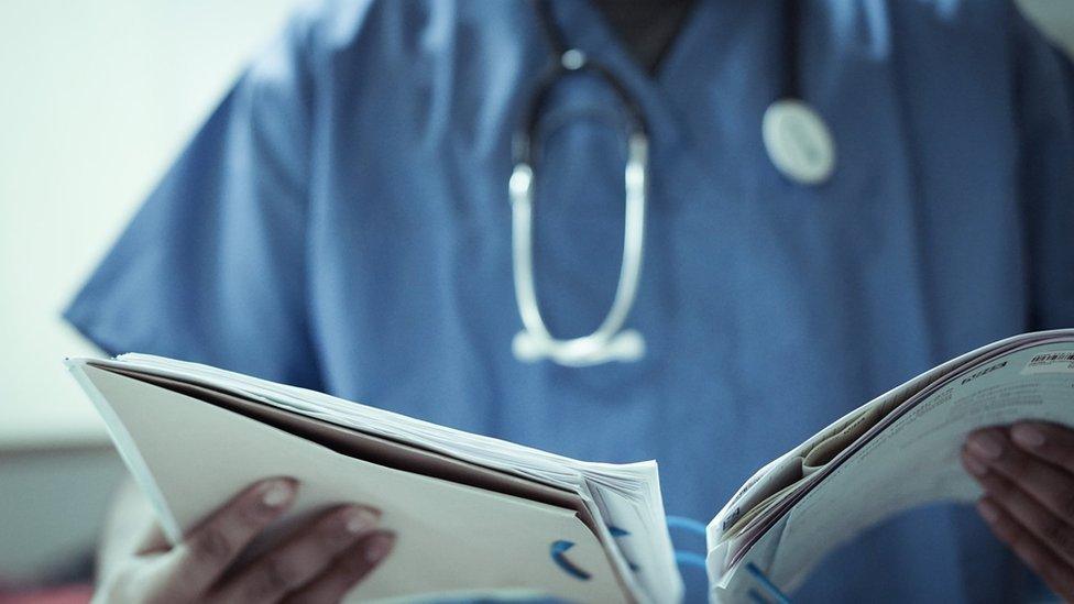 health worker holding documents