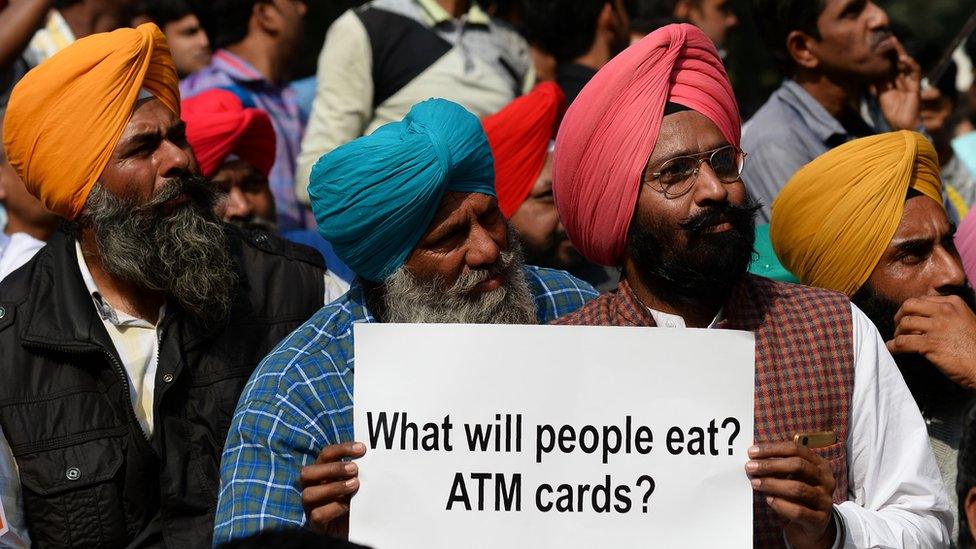 An man holding a placard during a protest against demonetisation in New Delhi on November 23, 2016.