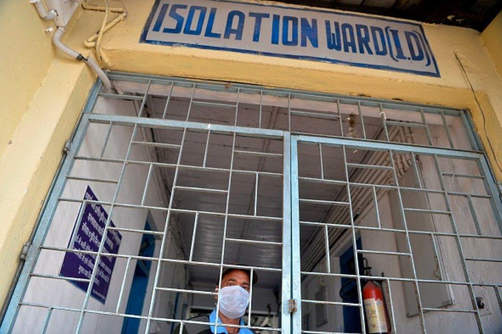 A security staff wearing a facemask stands at the emergency entrance of an isolation ward opened as a preventative measure following a SARS-like virus outbreak which began in the Chinese city of Wuhan, at the North Bengal Medical college and Hospital in Siliguri on February 4, 2020.