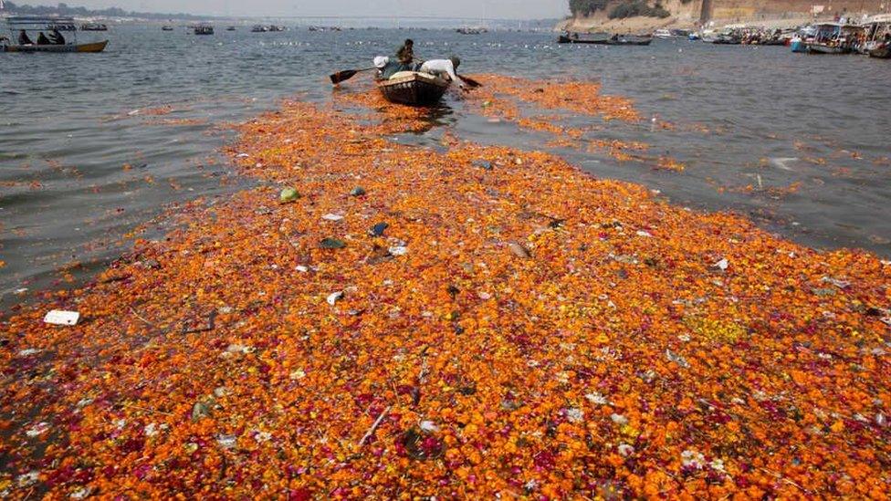 Waterways choked with discarded flowers are a common sight in India