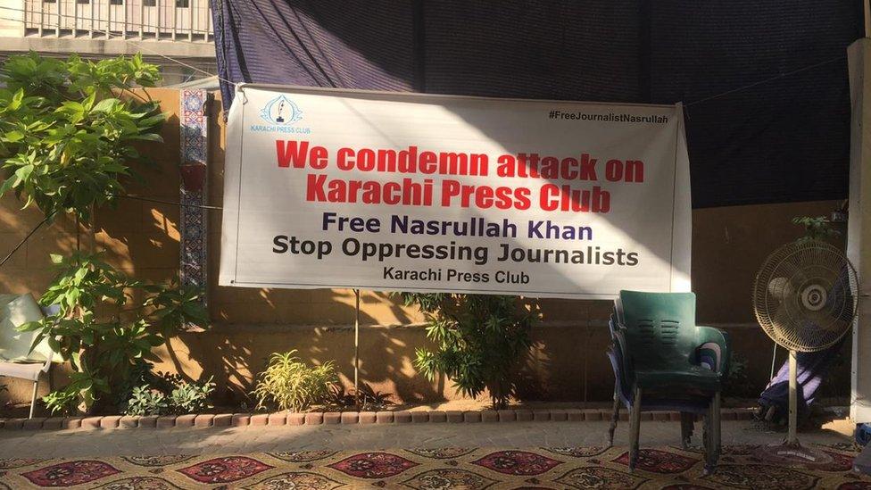 Sign at the Karachi press club reading: "We condemn attack on Karachi Press Club - Free Nasrullah Khan, Stop Oppressing Journalists"