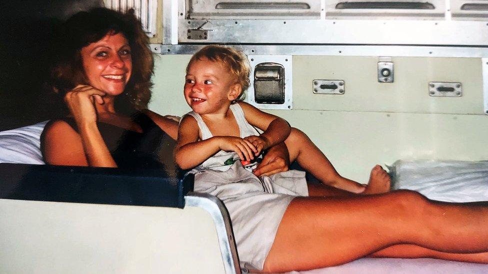 Jane with Calvin on a train in Asia, 1992