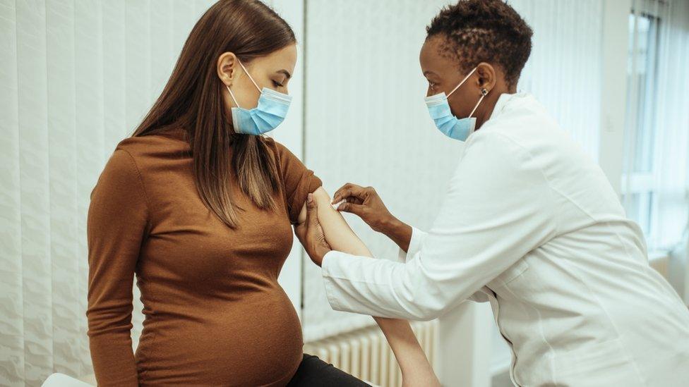 Pregnant woman being vaccinated