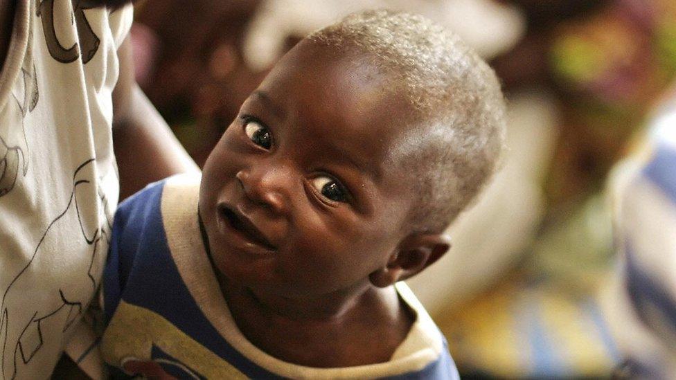 A mother holds her smiling child during a visit of United Nations (UN) First Lady Ban Sun-taek (not pictured) at the Princess Marie Louise Children's Hospital in Accra on April 20, 2008.