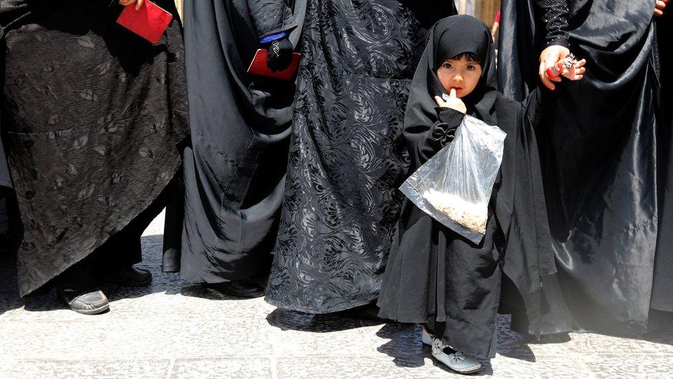 A veiled little Iranian girl stands in a line with her mother among women queing to vote in the Iranian presidential elections outside a polling station set up in the Abdol Azim shrine in the city of Shahre-Ray, south of the capital Tehran, Iran, 19 May 2017.