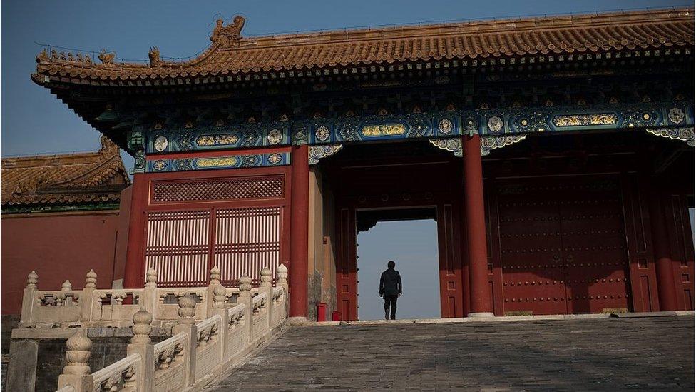 A man walks through a gate inside the Forbidden City in Beijing on 29 September 2016.