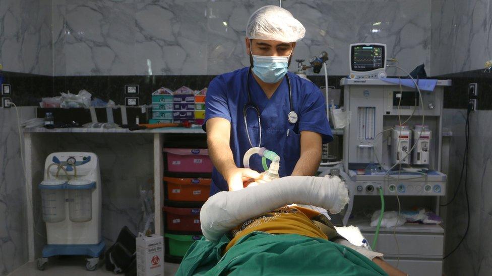 A Syrian doctor checks a child injured during a bombing after a surgery at a hospital in Syria's rebel-held Idlib province on September 10 2018