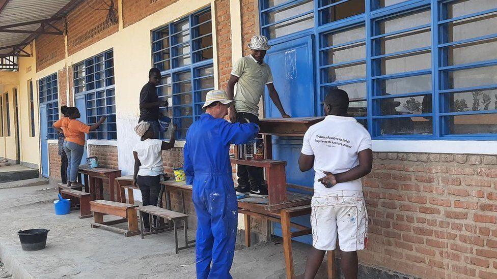 Volunteers painting school