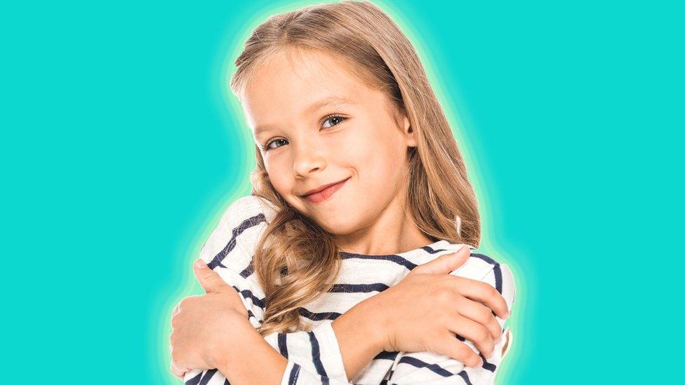 girl-hugs-herself.