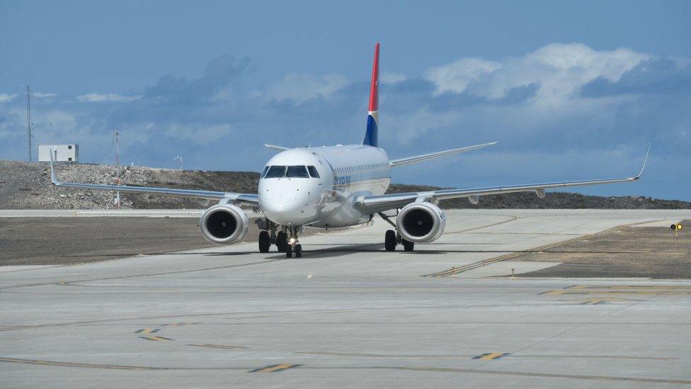 The third scheduled passenger plane taxis on the runway at St Helena airport after a two day delay due to harsh weather conditions on October 30, 2017