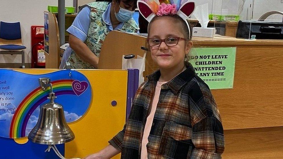 Summer Wyatt ringing the bell as she leaves hospital