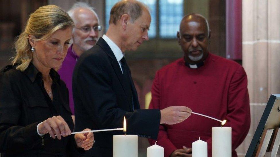 The Earl and Countess of Wessex lighting a candle at Manchester Cathedral