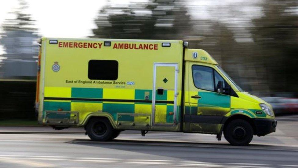 East of England Ambulance driving down a road