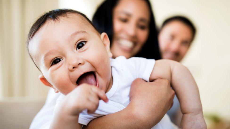 happy baby with mum and dad