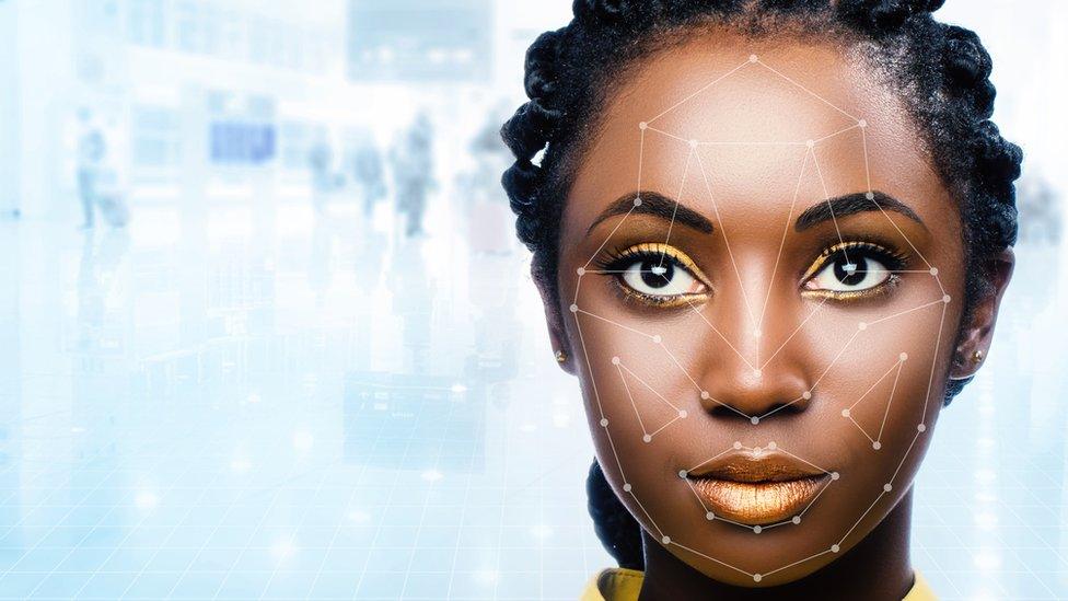 Black woman's face being scanned