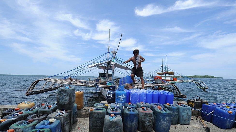 A crew member of one of the the fishing boats where a former Philippine Marine officer and his volunteers were to set sail for the disputed Scarborough shoal, disembarks from the boat at a pier in Masinloc town, Zambales province, 230 kilometres (140 miles) from Scarborough Shoal.