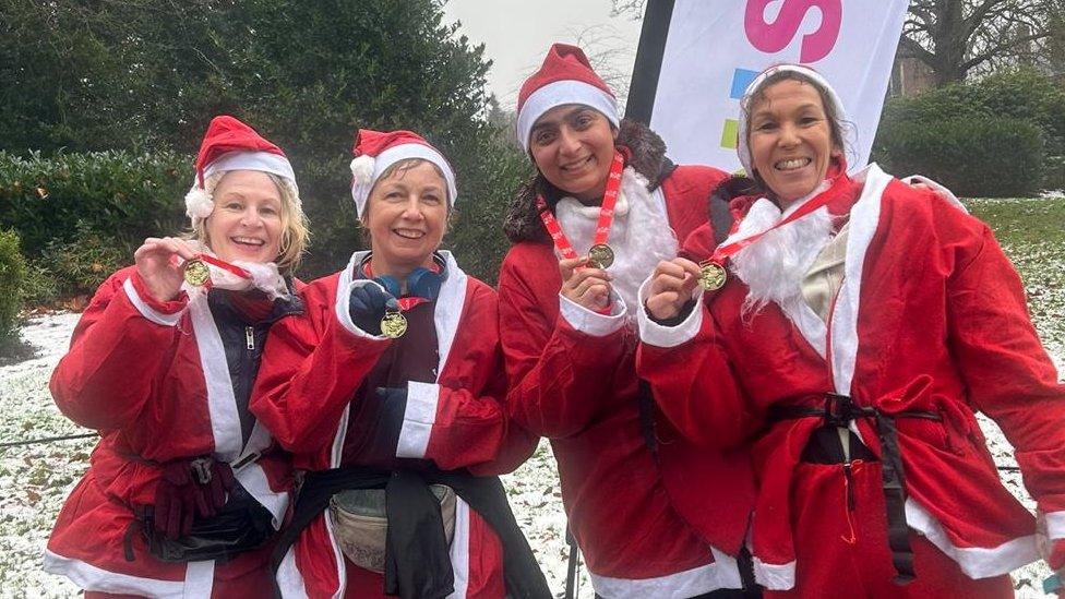 A group of runners with their medals