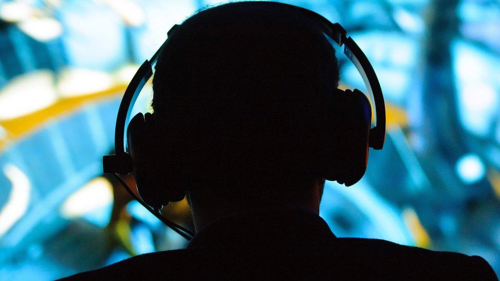 Silhouette of a man wearing headphones