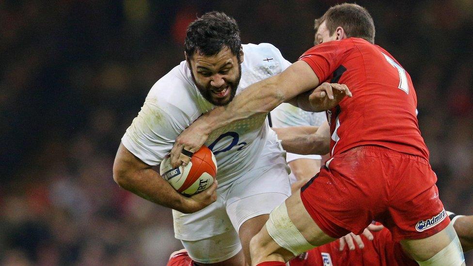 Billy Vunipola of England is tackled by Sam Warburton of Wales