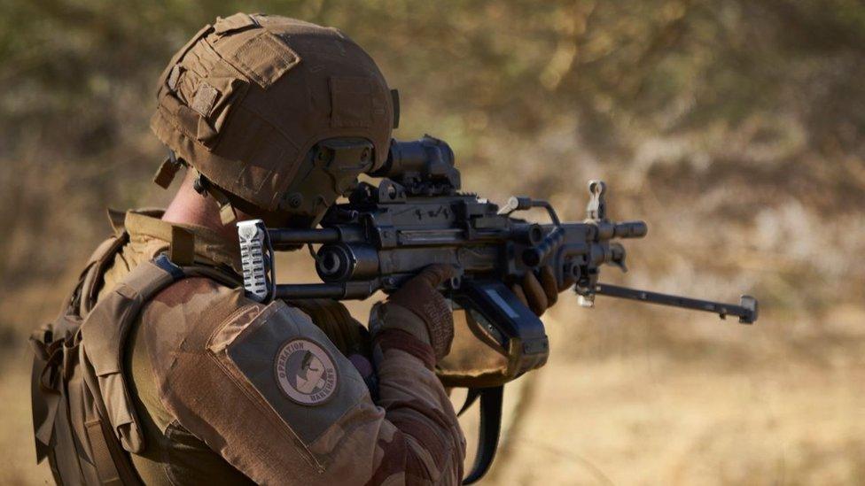 A soldier of the French Army monitors a rural area during the Barkhane operation in northern Burkina Faso on November 10, 2019.