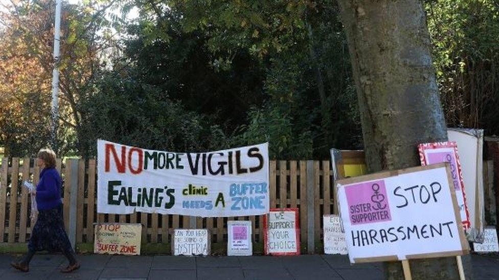 Signs calling for an end to vigils outside a clinic in Ealing