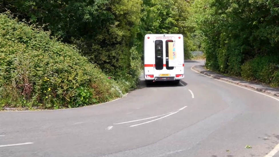 Westmount Rd with ambulance driving down it